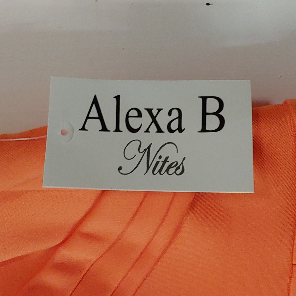 Off the shoulder Alexa B melon colored dress with a slit up the left side.